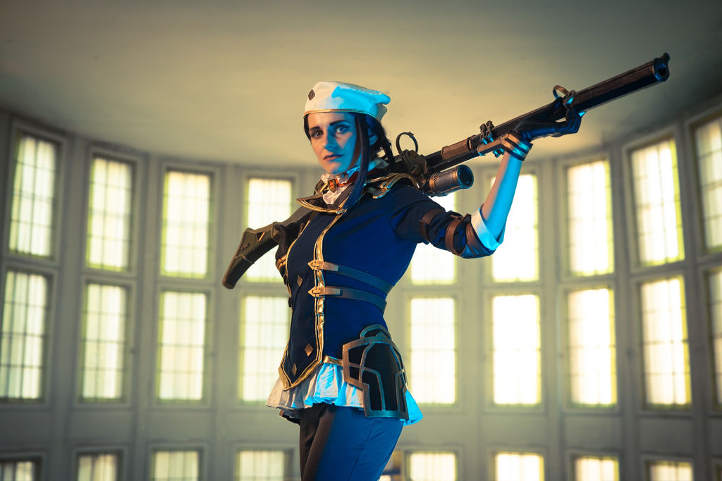Caitlyn from Arcane with a rifle over her shoulder in a window-lined rotunda
