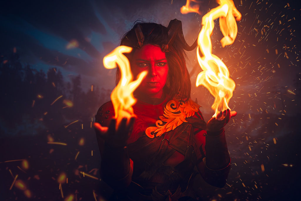 Karlach from Baldur's Gate 3 holding open flames in both hands, sparks flying